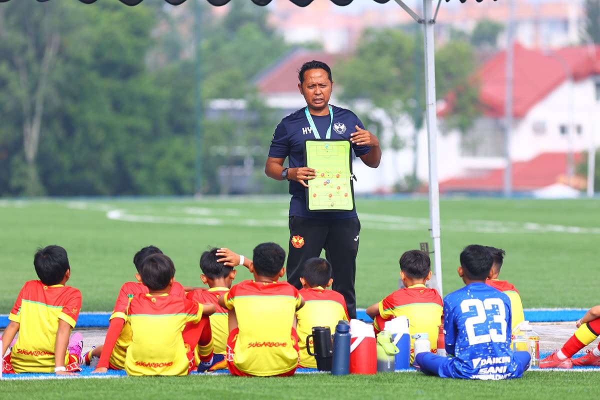 A coach briefs his team during a match