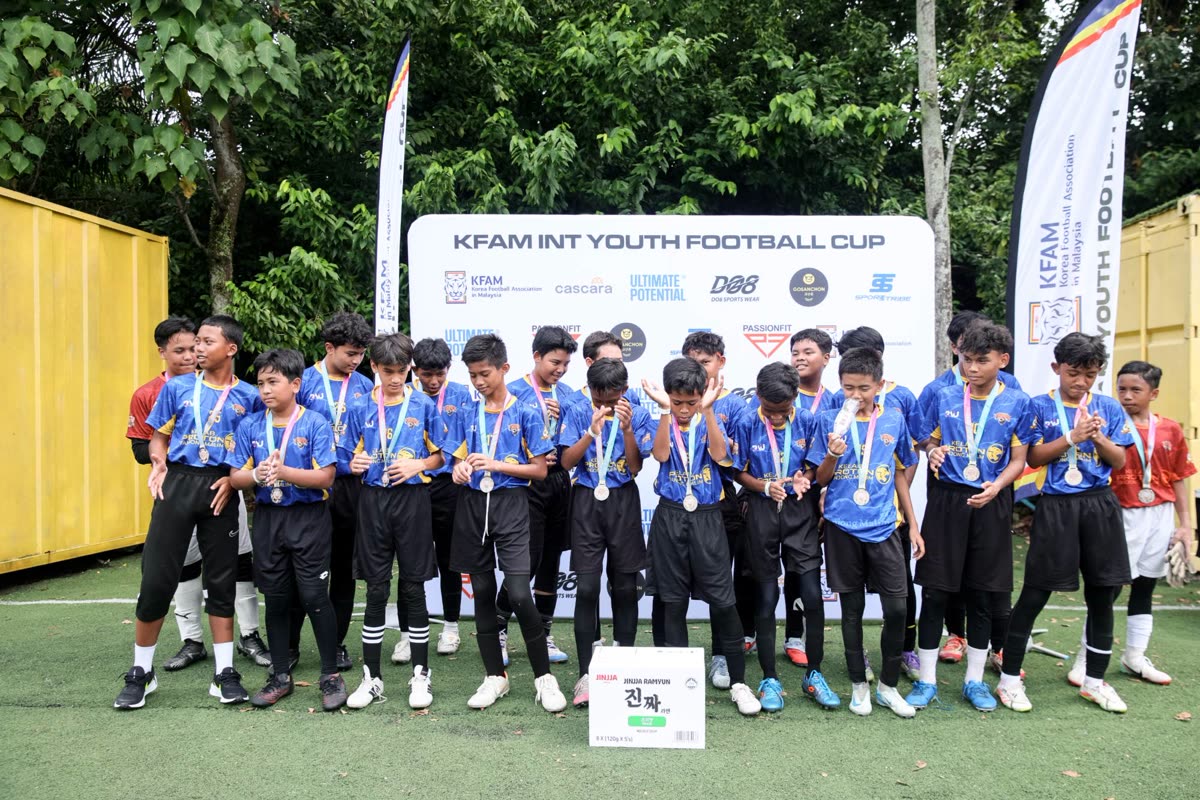 Team celebrating with medals at the June 2026 edition